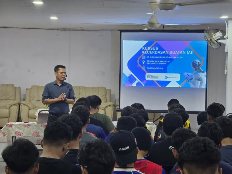 Coach Adi Zain addressing participants at an AI training session