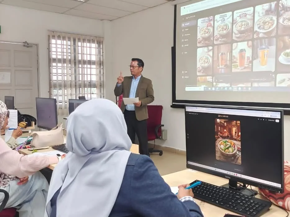 Coach Adi Zain Coach Adi Zain explaining visual content to participants in a computer lab