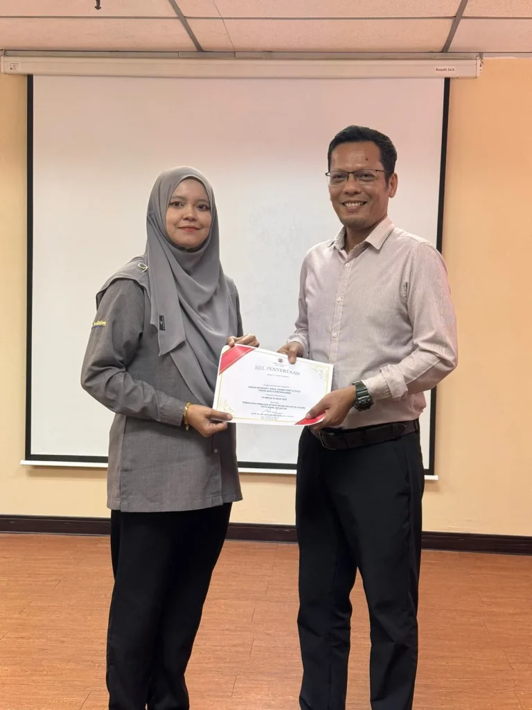 Trainer and participant at the conclusion of a computer skills workshop